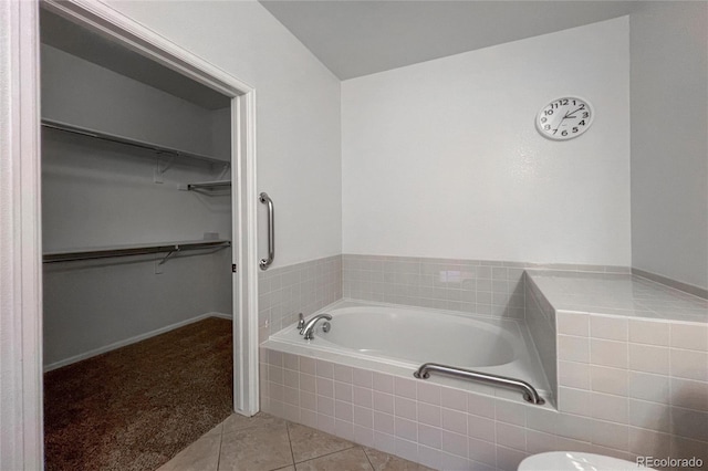 bathroom with tile patterned floors and tiled tub