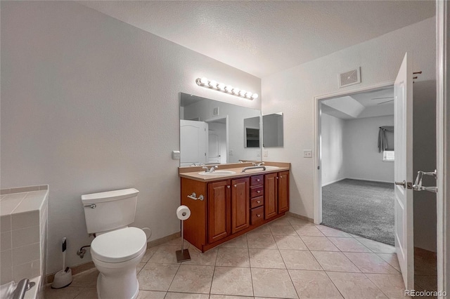 bathroom featuring tile patterned flooring, vanity, and toilet