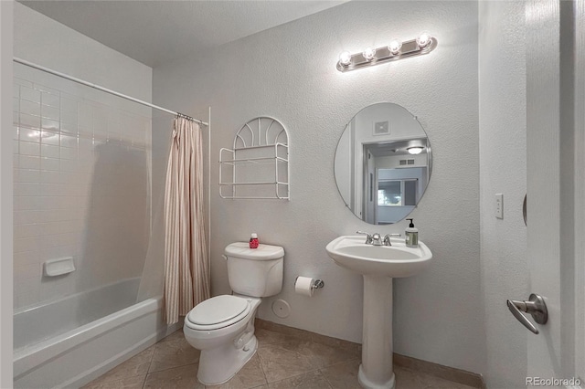 full bathroom with tile patterned flooring, sink, shower / tub combo with curtain, and toilet