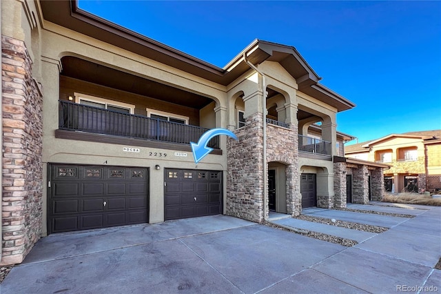 view of front of home with a garage and a balcony