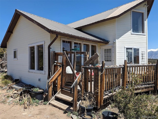 rear view of property featuring a deck