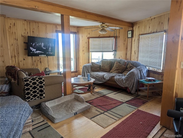 living room featuring hardwood / wood-style floors, wood walls, and beamed ceiling