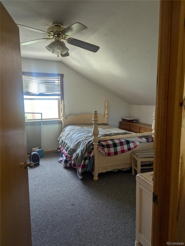 carpeted bedroom with ceiling fan and lofted ceiling