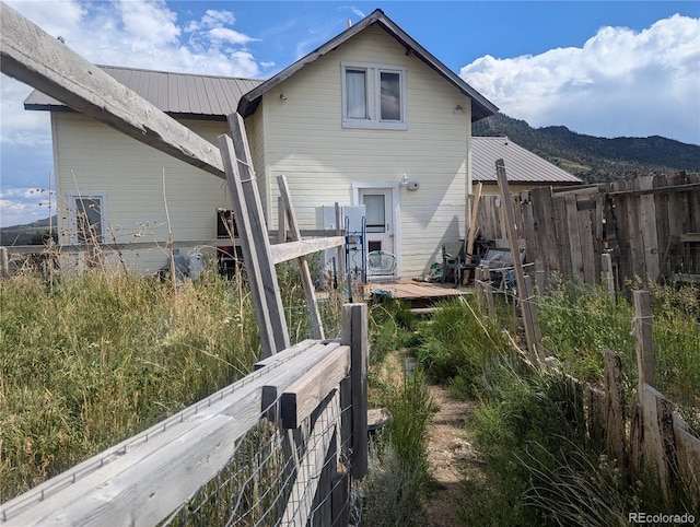 rear view of property featuring a mountain view