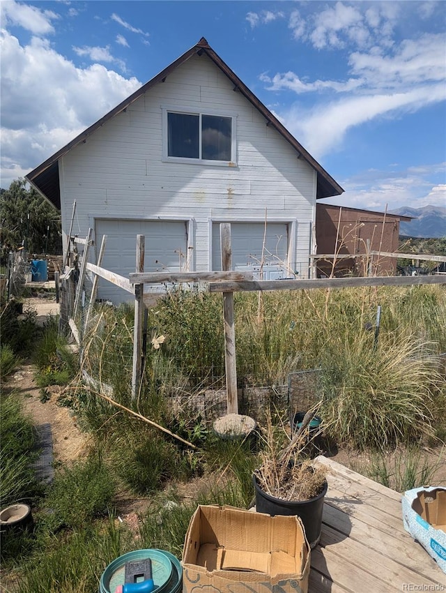 back of property featuring a garage