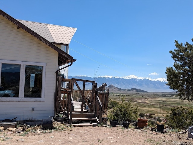 view of side of home with a mountain view