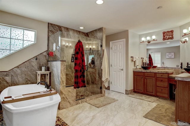 bathroom with vanity, plus walk in shower, and tile walls