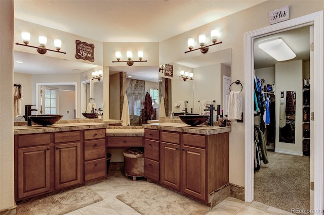 bathroom featuring tile patterned flooring and vanity