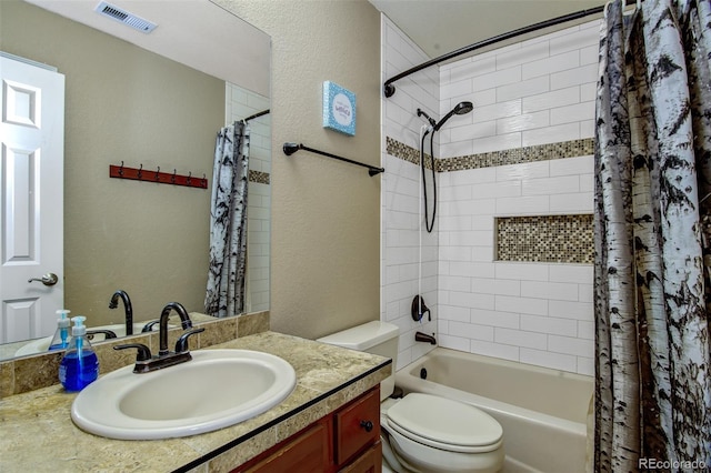 full bathroom with vanity, shower / tub combo with curtain, and toilet