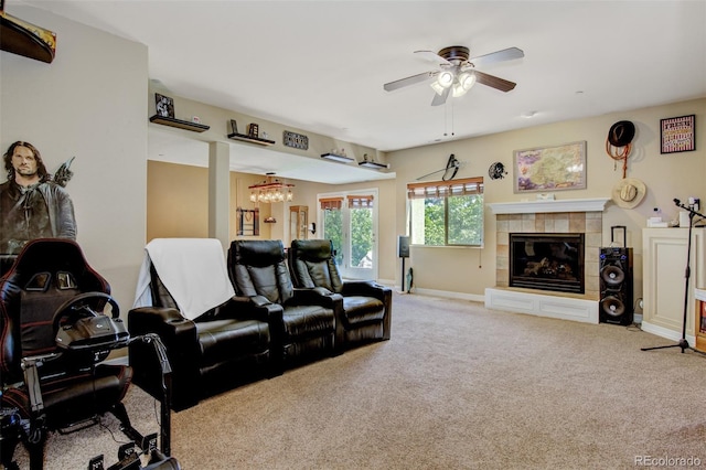 home theater room featuring light carpet, a fireplace, and ceiling fan