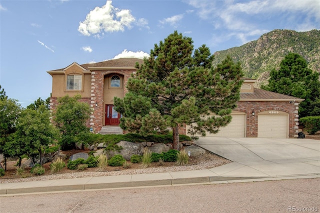 view of front facade featuring a garage and a mountain view