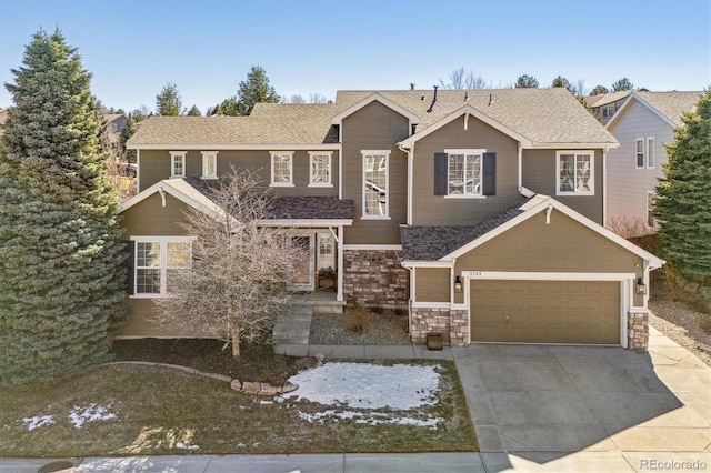 view of front facade featuring stone siding, roof with shingles, and driveway