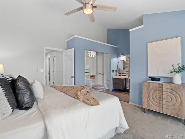 bedroom with carpet, connected bathroom, baseboards, and ceiling fan