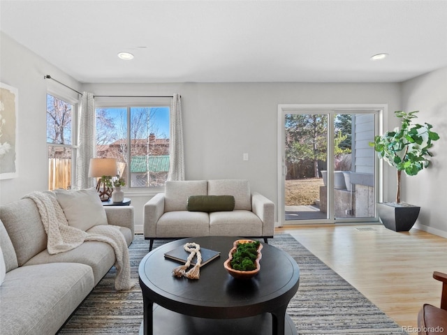 living room featuring wood finished floors, a wealth of natural light, and recessed lighting