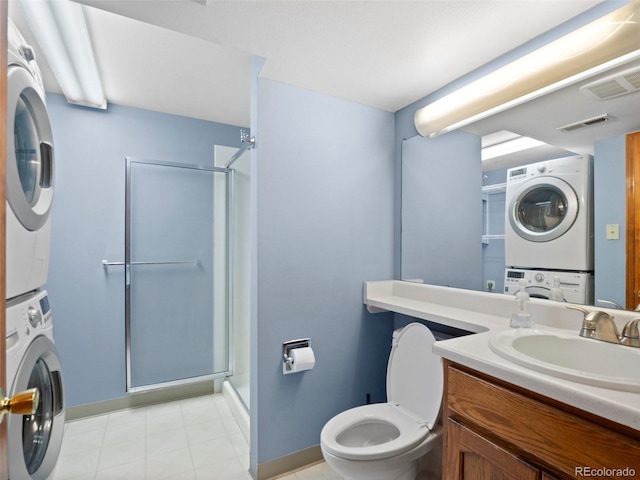 bathroom featuring stacked washer and dryer, a stall shower, visible vents, and toilet