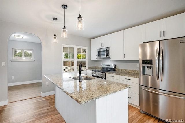 5100 Clay St, Denver, CO 80221 - kitchen featuring stainless steel appliances, a sink, baseboards, and light wood-style flooring
