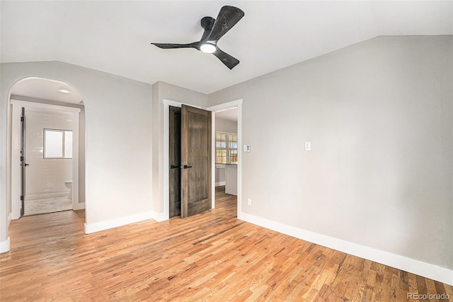 5100 Clay St, Denver, CO 80221 - unfurnished bedroom with baseboards, vaulted ceiling, light wood-style flooring, arched walkways, and ceiling fan
