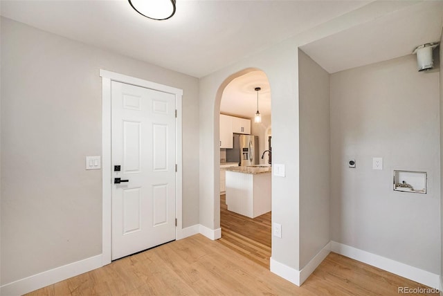 5100 Clay St, Denver, CO 80221 - entryway featuring arched walkways, light wood finished floors, and baseboards