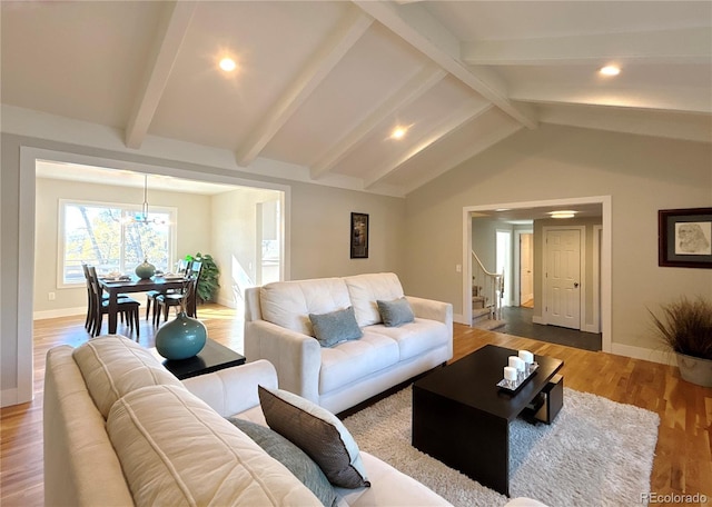 living room with hardwood / wood-style floors and lofted ceiling with beams