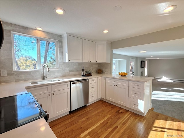 kitchen with stainless steel dishwasher, white cabinets, light wood-type flooring, and sink