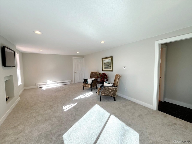 sitting room with light colored carpet and a baseboard heating unit