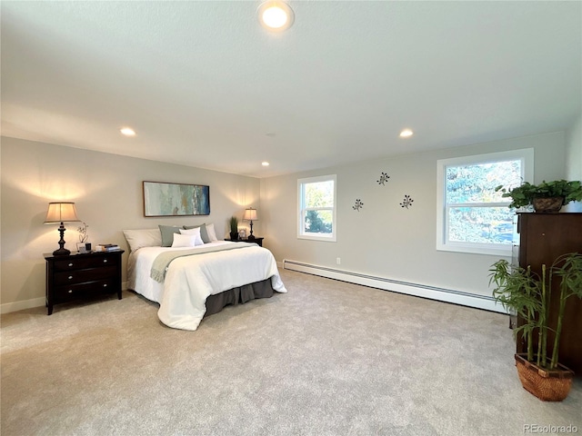 bedroom featuring light carpet and a baseboard heating unit