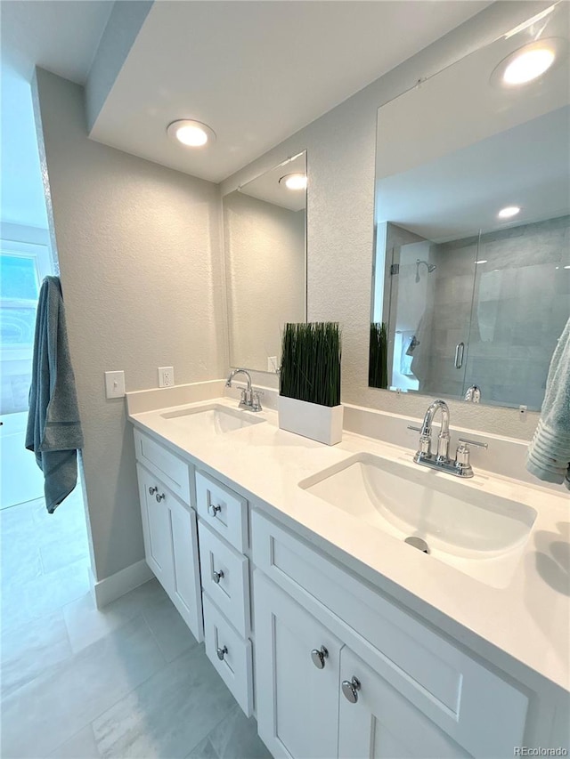 bathroom featuring vanity and an enclosed shower