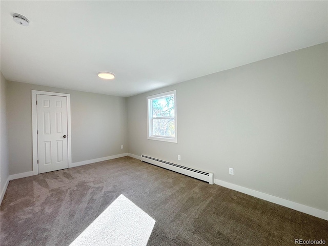 spare room with carpet and baseboard heating