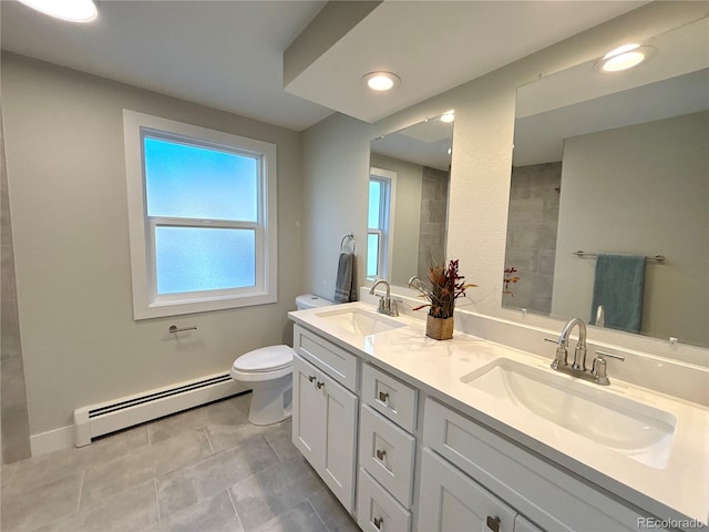 bathroom with tile patterned flooring, vanity, toilet, and a baseboard radiator