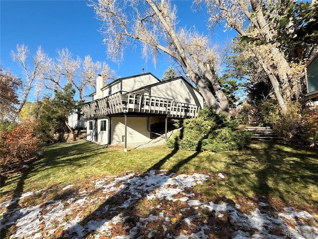 view of side of property with a lawn and a wooden deck