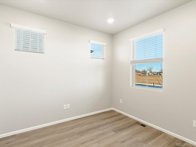 spare room with light wood-type flooring