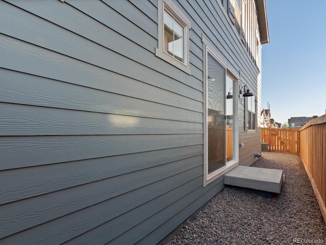 view of side of property with central air condition unit