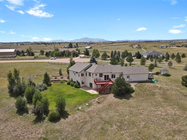 birds eye view of property featuring a mountain view and a rural view