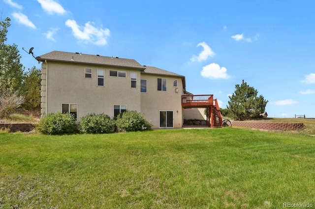 rear view of property with a lawn and a deck