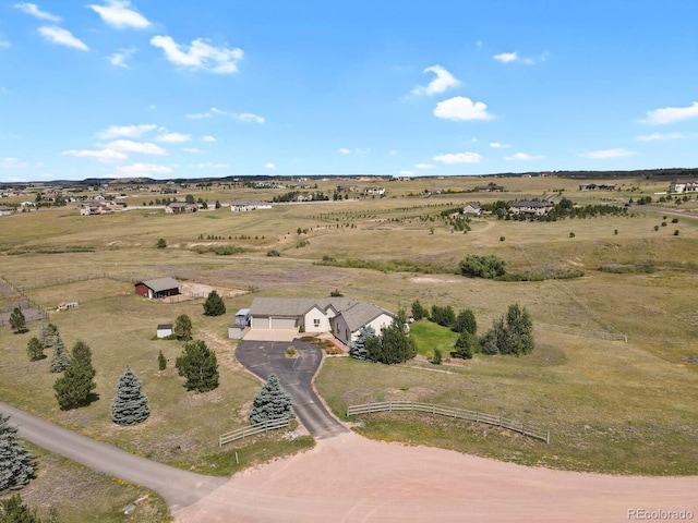 birds eye view of property with a rural view