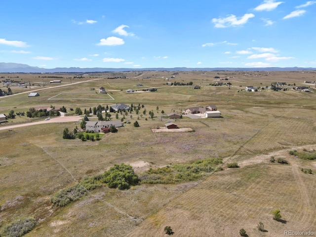 drone / aerial view featuring a mountain view and a rural view