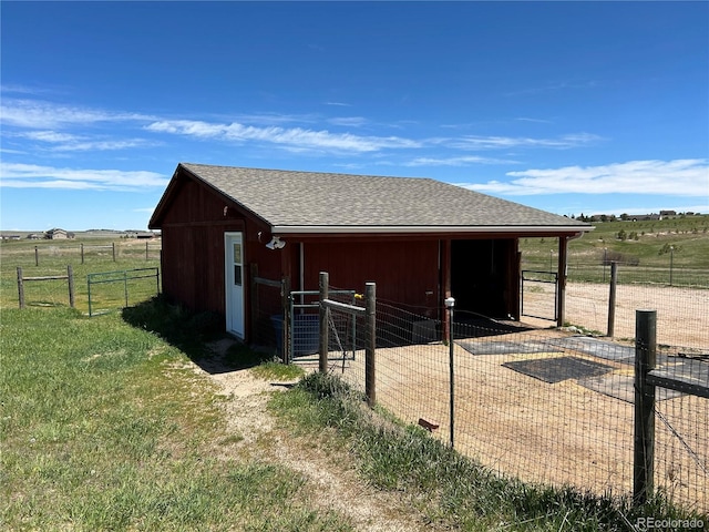 view of stable with a rural view