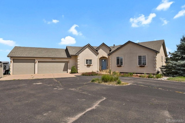 ranch-style home featuring a garage