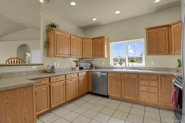 kitchen with light tile patterned flooring, sink, stainless steel appliances, and vaulted ceiling