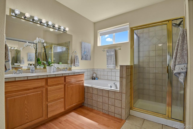 bathroom featuring vanity, separate shower and tub, and wood-type flooring