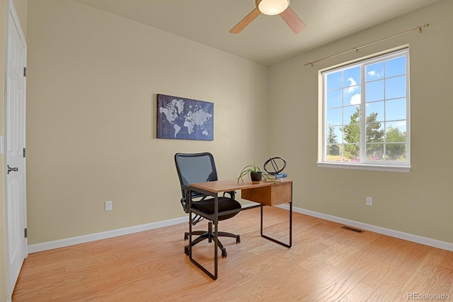 home office with ceiling fan and light hardwood / wood-style floors