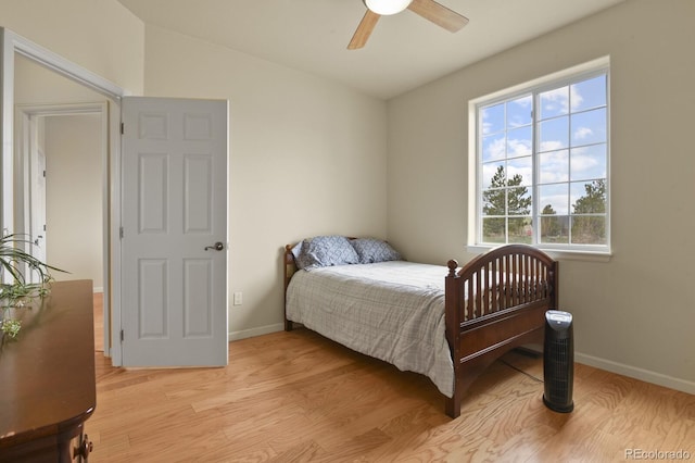 bedroom with ceiling fan, light hardwood / wood-style flooring, and lofted ceiling