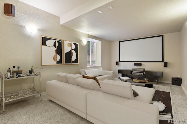 cinema room with light carpet and a textured ceiling