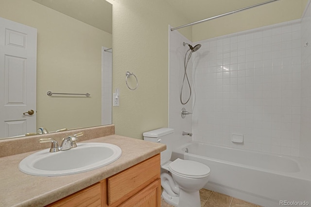 full bathroom featuring tile patterned floors, vanity, toilet, and tiled shower / bath combo