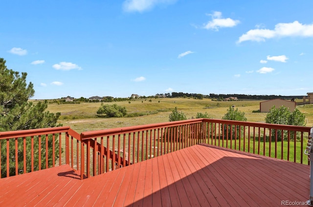 wooden terrace featuring a rural view