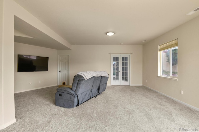 carpeted living room featuring french doors