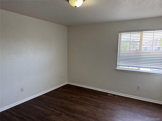 13959 Eudora St, Thornton, CO 80602 - empty room with wood finished floors, baseboards, and a textured ceiling