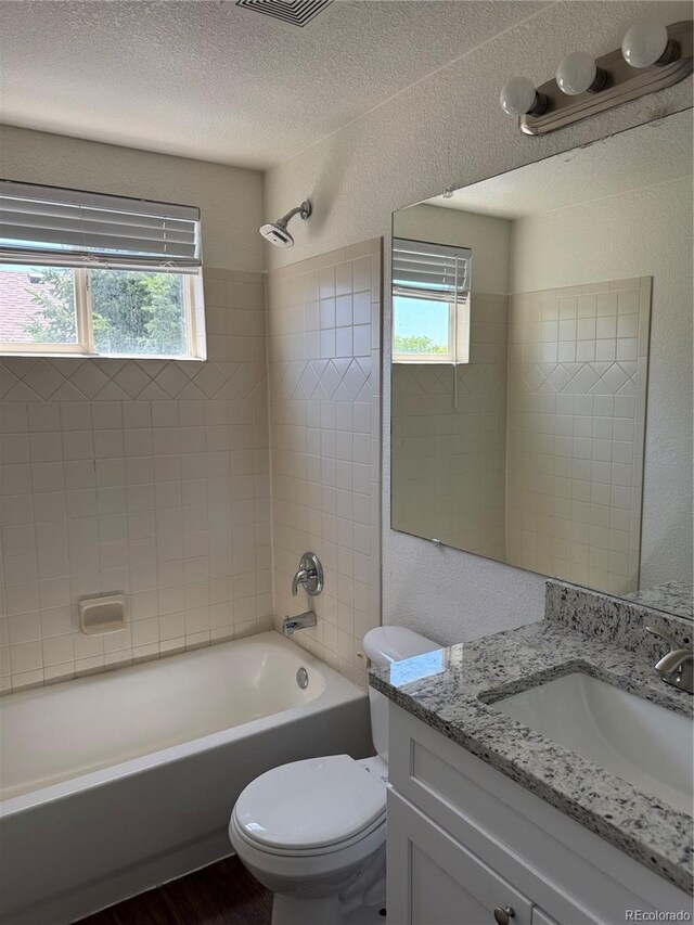 13959 Eudora St, Thornton, CO 80602 - full bath with vanity, shower / washtub combination, toilet, a textured ceiling, and wood finished floors