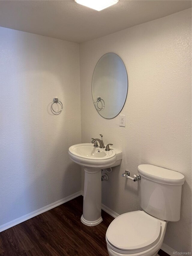 13959 Eudora St, Thornton, CO 80602 - bathroom featuring wood finished floors, baseboards, and toilet