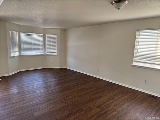 13959 Eudora St, Thornton, CO 80602 - unfurnished room with a textured ceiling, dark wood-style floors, and baseboards